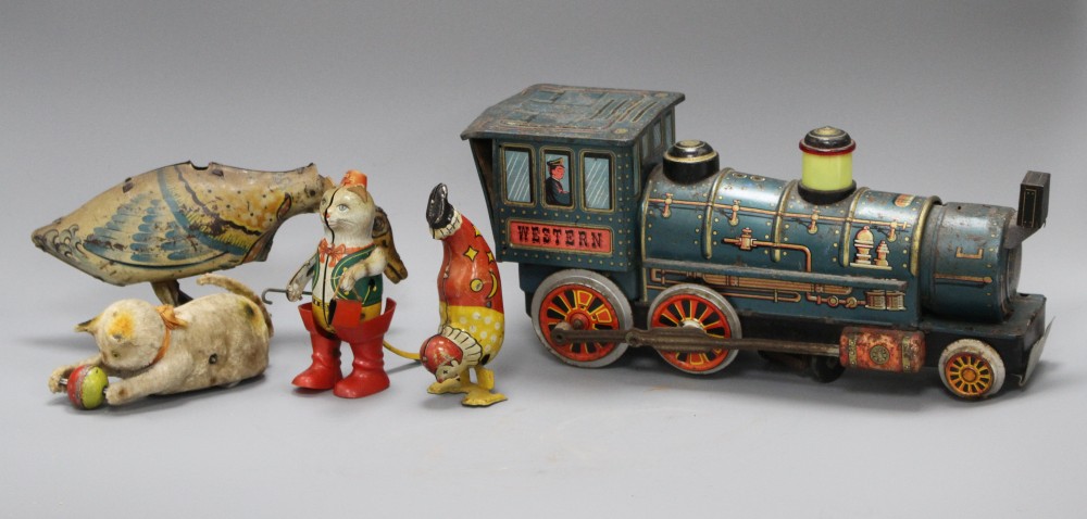 A clockwork cat and ball, and four assorted tinplate toys